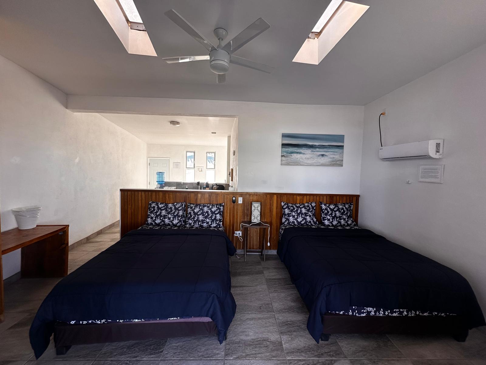 Habitación amplia con dos camas y aire acondicionado en Baja Playa Sol